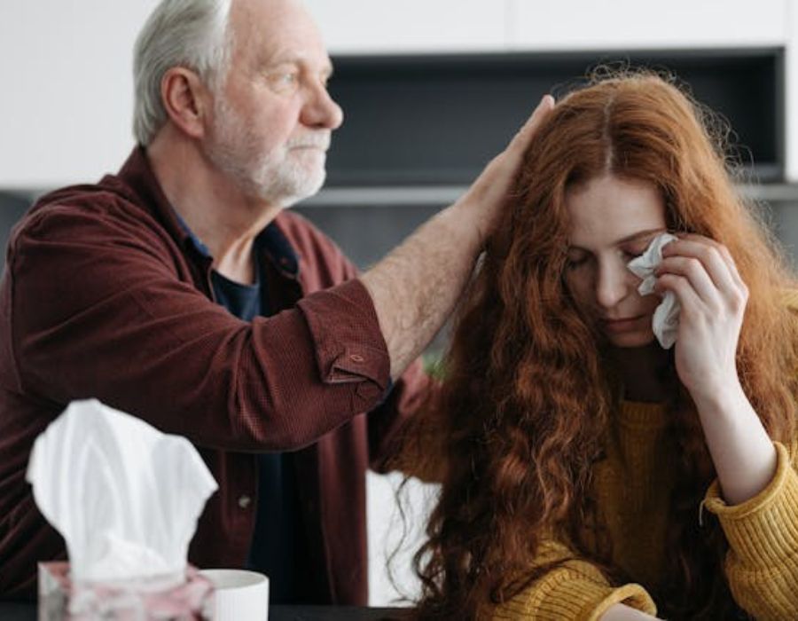 An Elderly Man Consoling a Woman