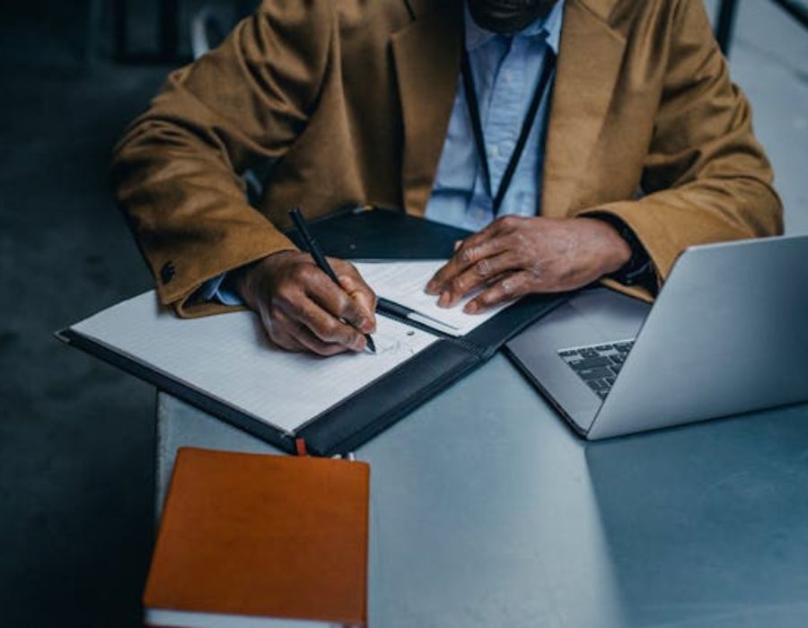 a man writing something down on a piece of paper
